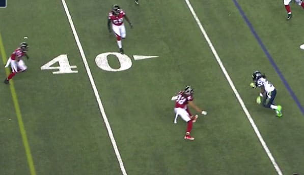Jalen Collins (No. 32) puts pressure on Seattle RB Alex Collins (No. 36) while De'Vondre Collins (No. 59) lurks.